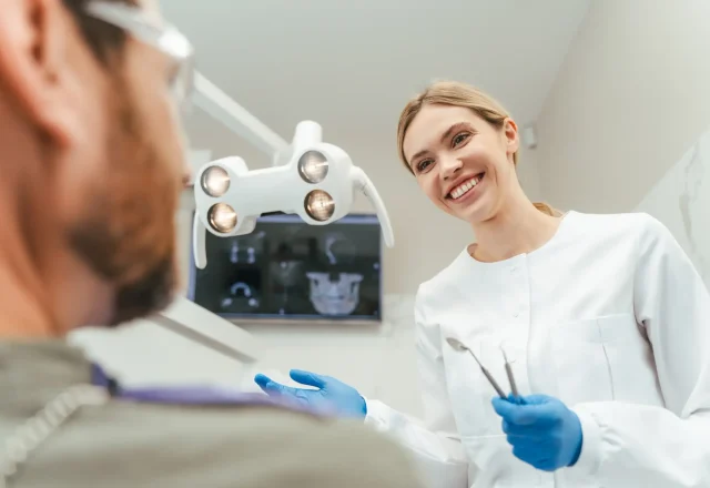 06- implantsmiling-dentist-talking-with-patient-in-modern-den-2026-01-08-05-08-27-utc 1