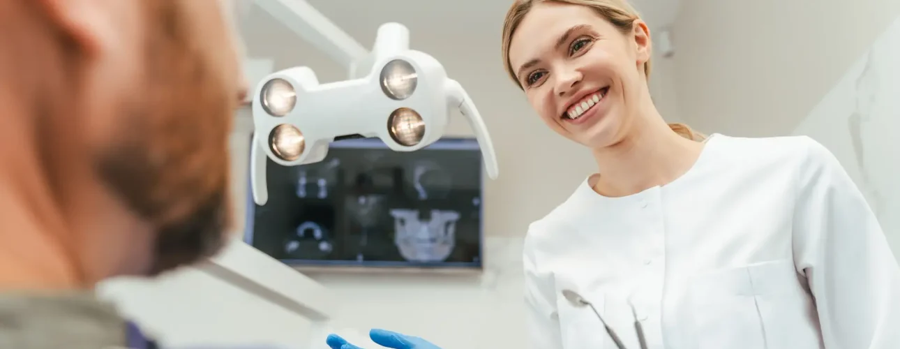 06- implantsmiling-dentist-talking-with-patient-in-modern-den-2026-01-08-05-08-27-utc 1